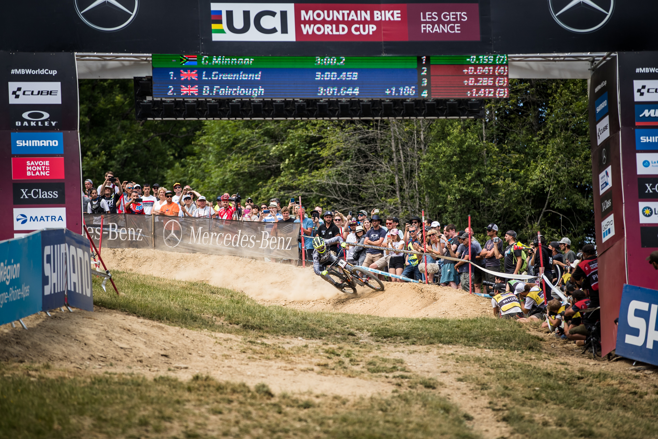 Greg Minnaar banks it in hard through the final berm with his name in green on the board for the moment.